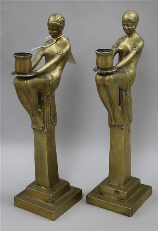 A pair of figural brass candlesticks height 42cm